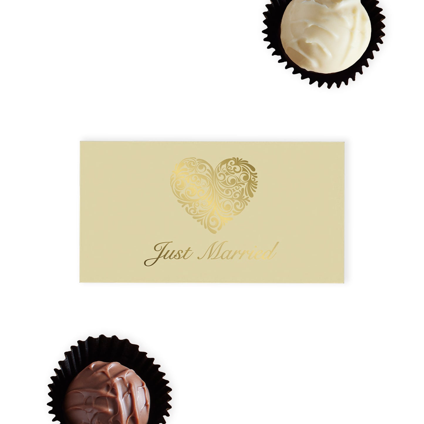 "Just Married" Chocolate Gift Box, an exquisite offering that pairs elegance with indulgence.  This cream-coloured gift box is beautifully adorned with an ornate gold heart and stylish "Just Married" font on the top, making it a standout addition to any wedding celebration.  Inside, discover two delicious hand-finished truffles, one milk and one white chocolate