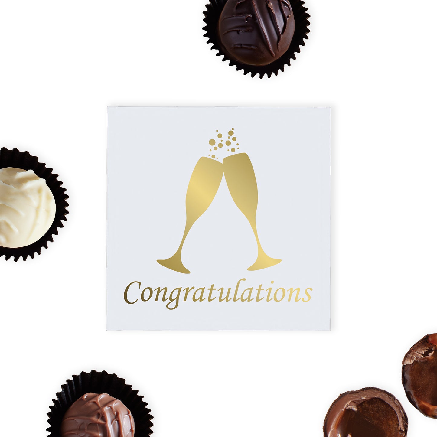 "Congratulations" Chocolate Gift Box, designed to mark every achievement with a touch of Luxury.  This elegant white Luxury box features gold foil-printed champagne glasses and the word "Congratulations," making it a sophisticated choice for any congratulatory occasion.  Inside, recipients will find four exquisite hand-finished truffles, assorted milk, dark and white truffles