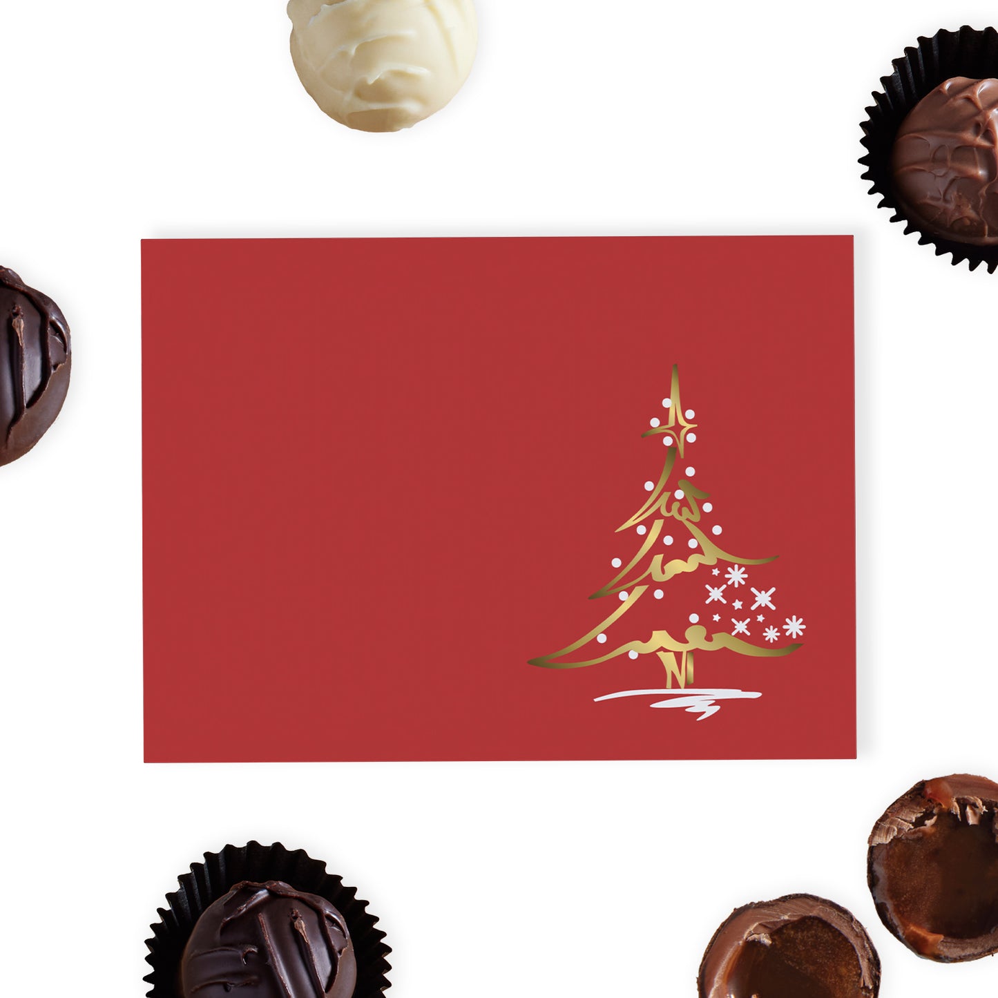 This luxurious red gift box is adorned with a foil-blocked Christmas tree design on the lid, adding a sophisticated touch to your holiday gifting. Inside, discover a selection of six delicious hand-finished truffles, crafted from the finest dark, milk, and white chocolates, each offering a unique and indulgent flavour experience