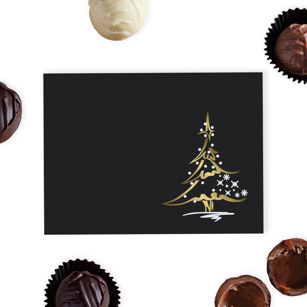 This luxurious black gift box is adorned with a foil-blocked Christmas tree design on the lid, adding a sophisticated touch to your holiday gifting. Inside, discover a selection of six delicious hand-finished truffles, crafted from the finest dark, milk, and white chocolates, each offering a unique and indulgent flavour experience