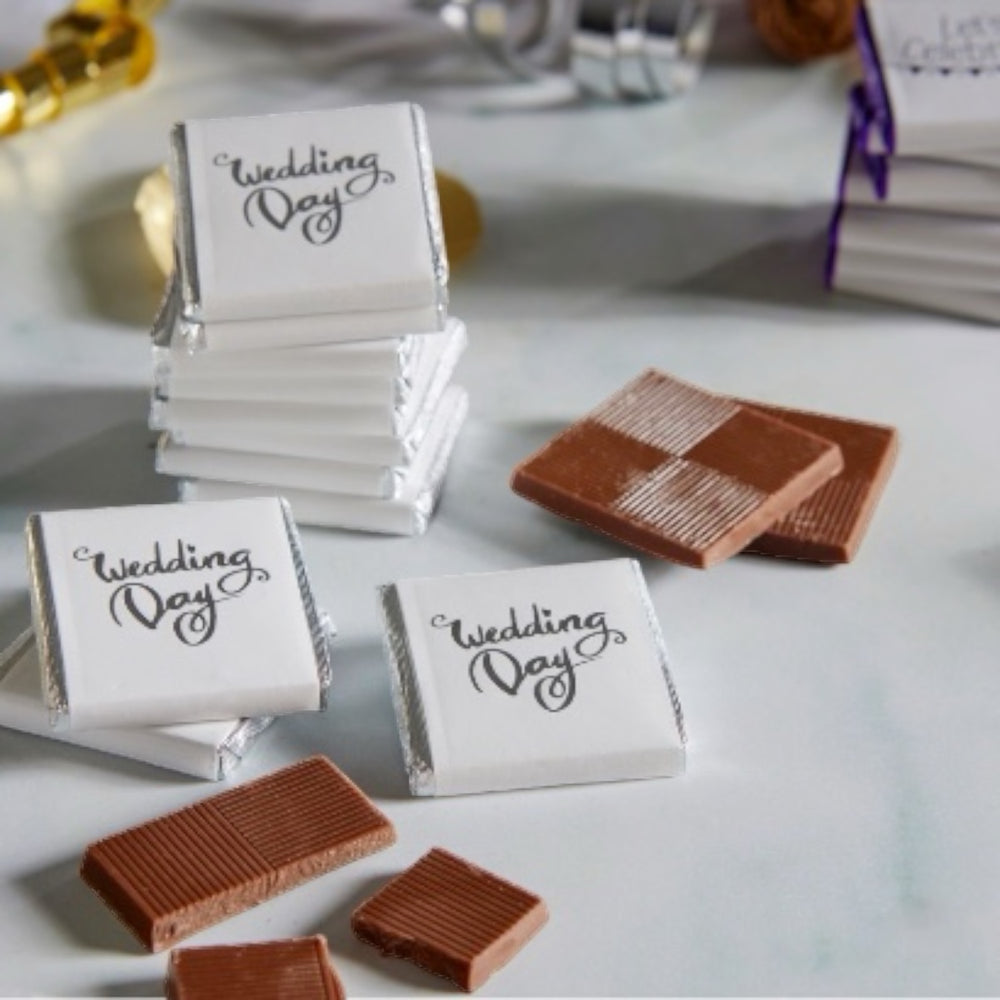 Milk Chocolate Neapolitans, designed to celebrate love and union. Each chocolate is delicately wrapped in luxurious foil and encased in a pristine white paper wrapper, beautifully adorned with 'wedding day' in graceful silver print. This bulk 2kg box, containing 400 individually wrapped chocolates