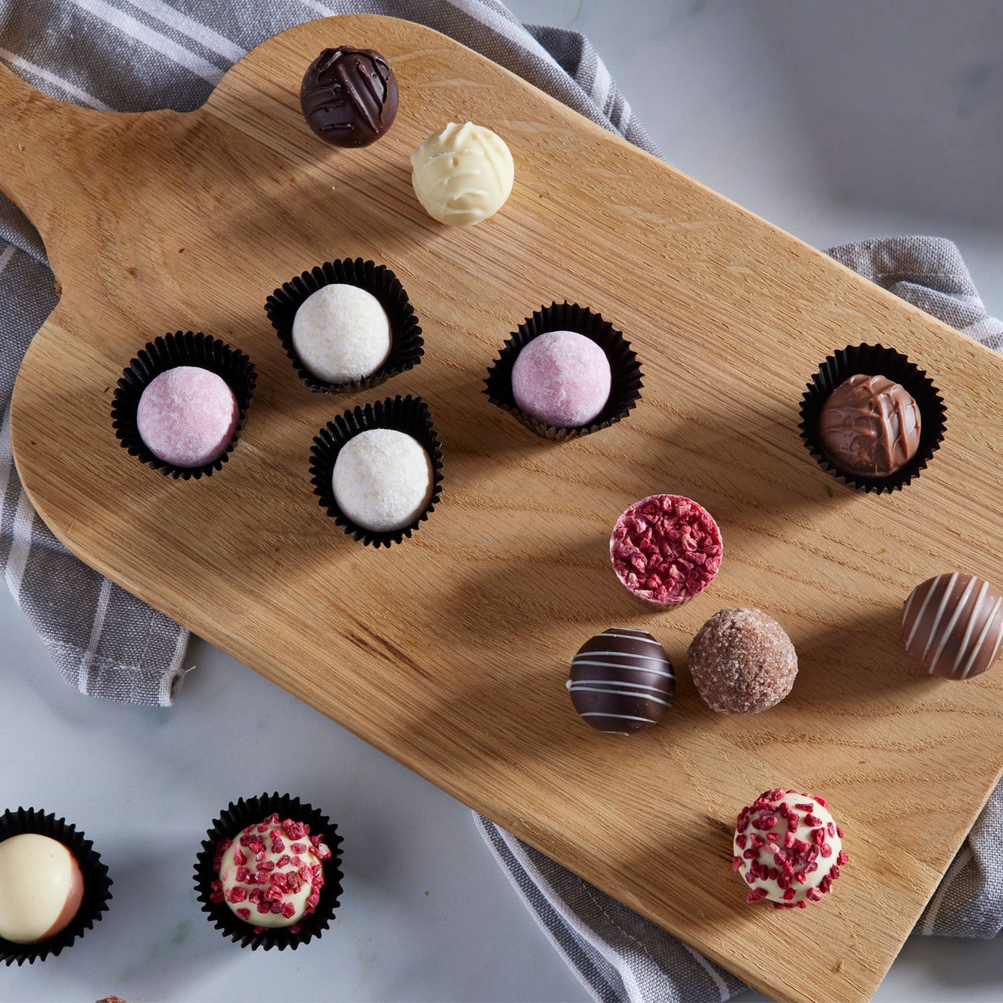 Luxurious White Chocolate Raspberry and Marc de Champagne Truffle Bulk Box, finished with freeze dried raspberry pieces